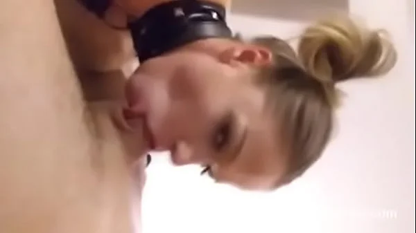 Tattoed blonde slave in fishnets sucking a dick